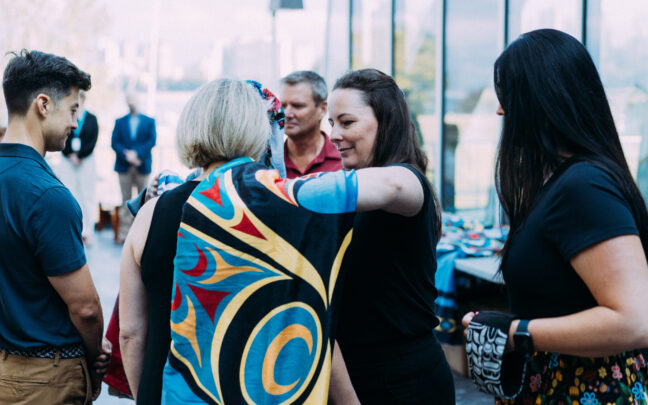 A member of the CHCPBC Board having a traditional blanket draped over their shoulder